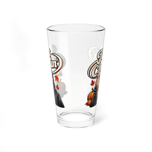 A clear pint glass with a decorative autumn-themed graphic featuring a witch, a pumpkin, and stylized text, shown on a plain white background.