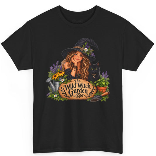 A black short-sleeve crewneck t-shirt featuring a colorful graphic print of a witch sitting in a garden with the text 'The Wild Witch Garden' on a wooden sign.