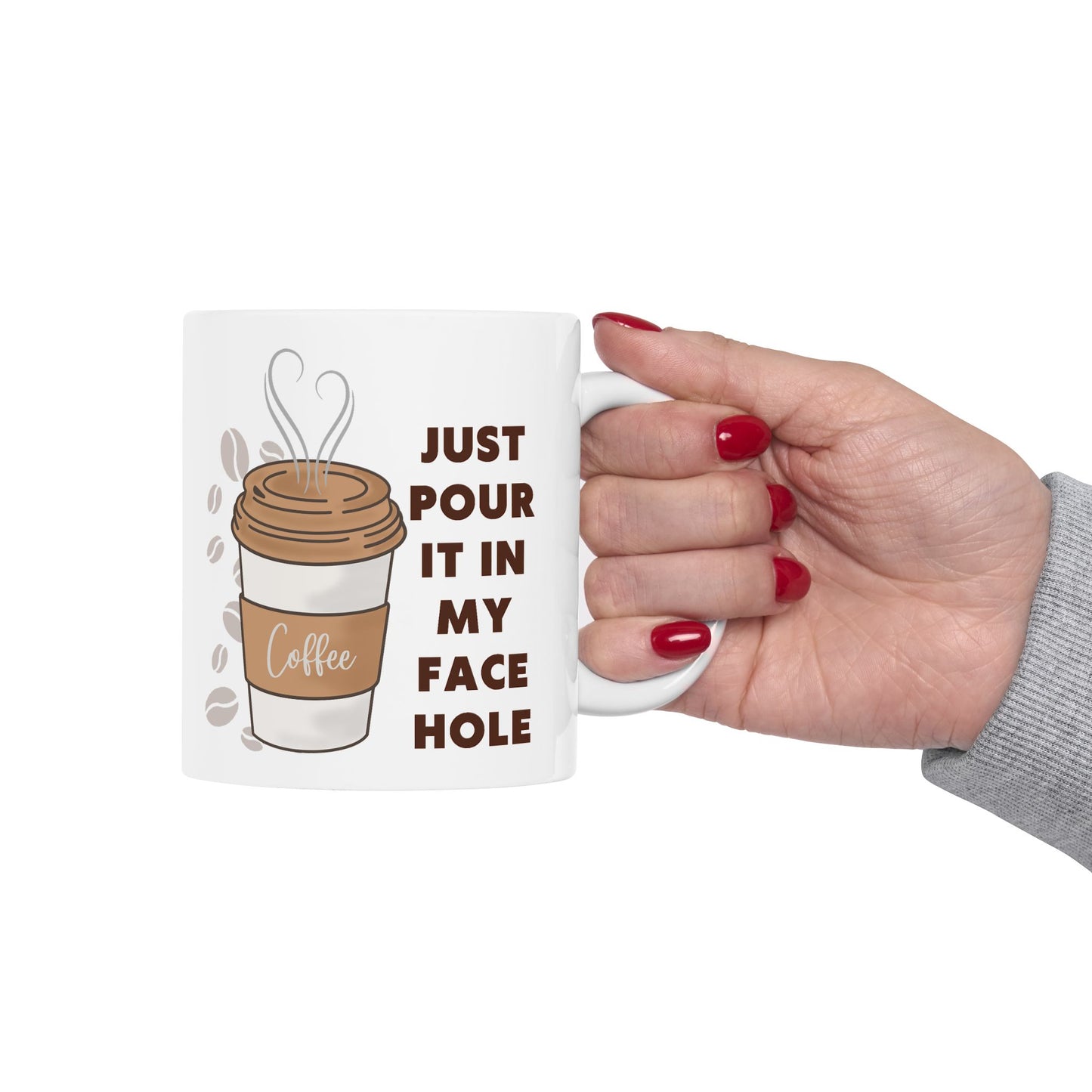 Mug with coffee graphic and text held by a hand on a white background