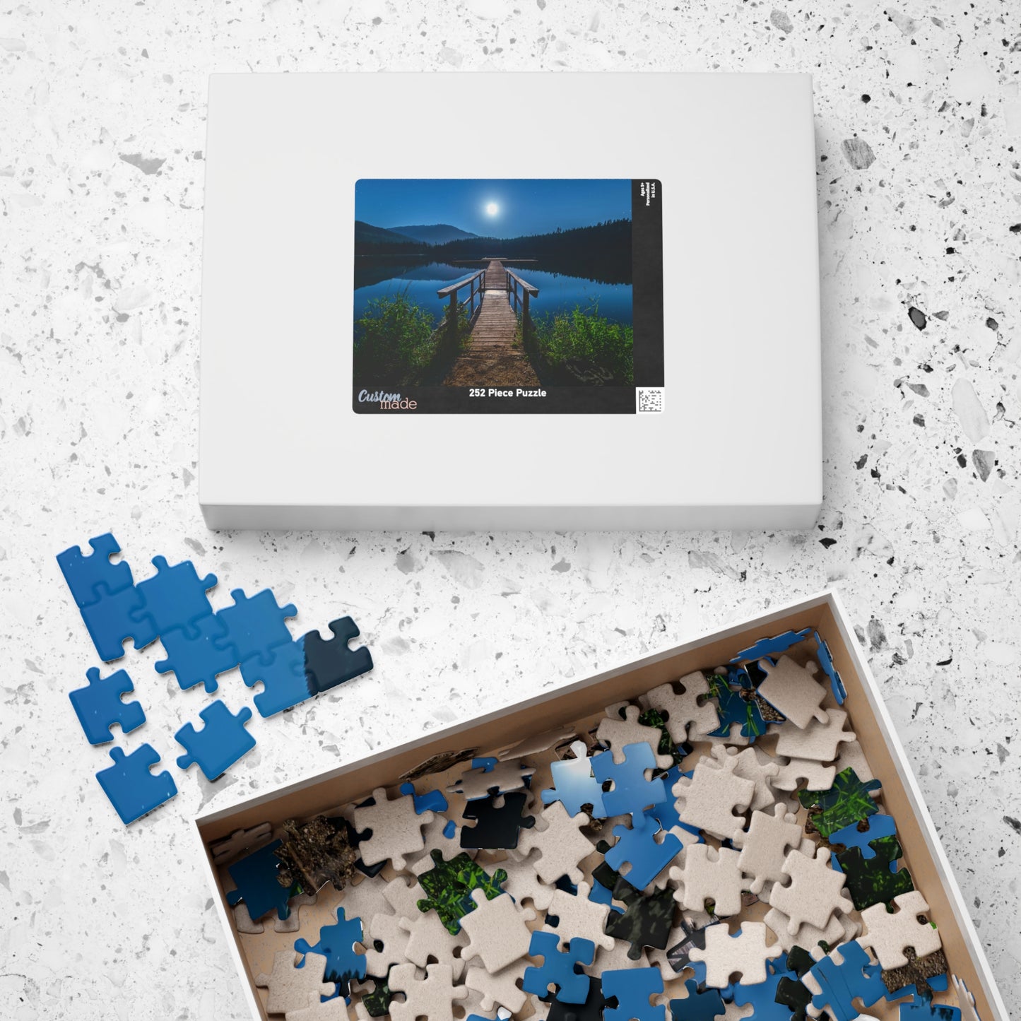 Experience the calming beauty of the Blue Moon At The Lake Puzzle. With 110 to 1014 pieces, this puzzle is perfect for all levels. Immerse yourself in the artistry of the blue moon reflecting on the serene lake, and feel the peace and tranquility it brings. A delightful challenge for any puzzle enthusiast.
