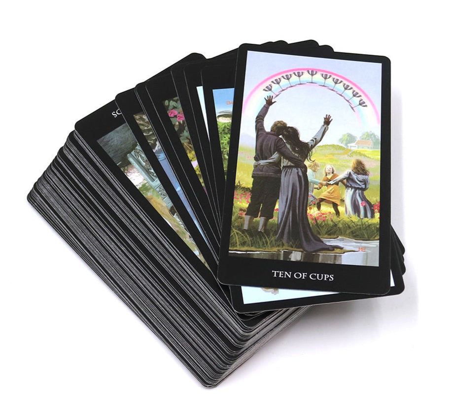 Set of tarot cards with a focus on the 'Ten of Cups' card showing people and a rainbow arch.