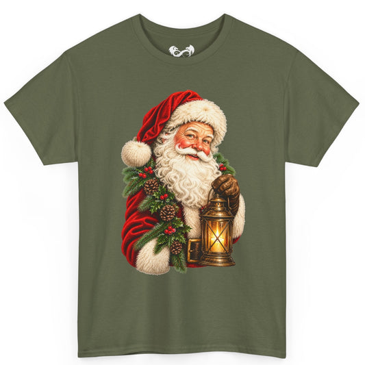 An olive green short-sleeve t-shirt featuring a large graphic print of a vintage Santa Claus holding a glowing lantern, set against a plain white background.