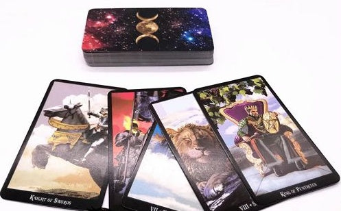 Set of tarot cards with a tarot card holder featuring celestial design.