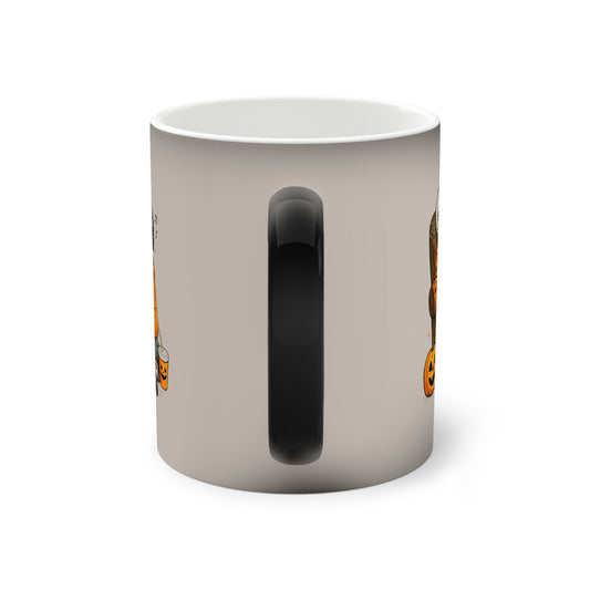 A white ceramic mug with a black handle, featuring a Halloween-themed graphic print of a witch's broom on the side, shown against a plain white background.