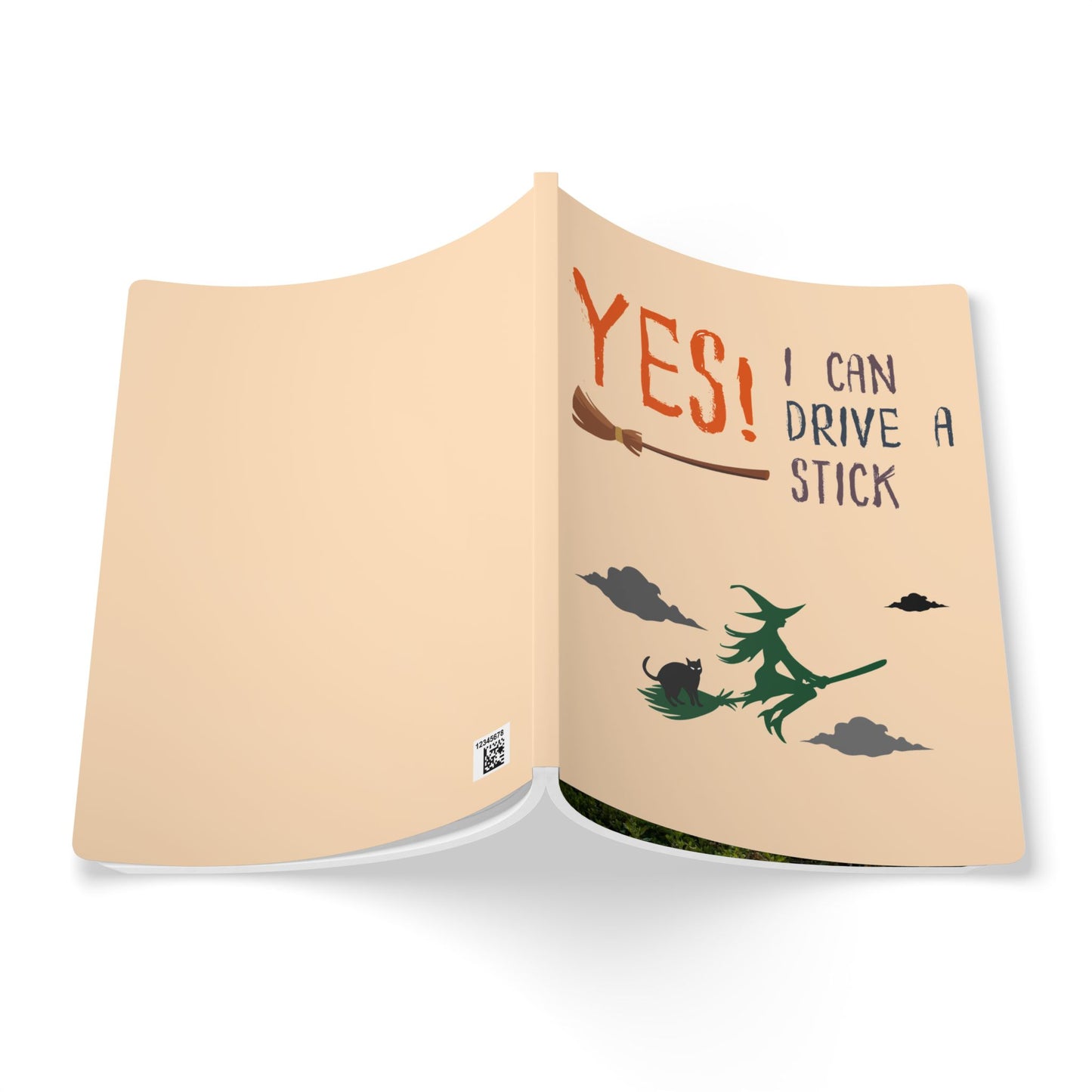 Open book with a witch on a broomstick and text 'YES! I can drive a stick' on beige pages.