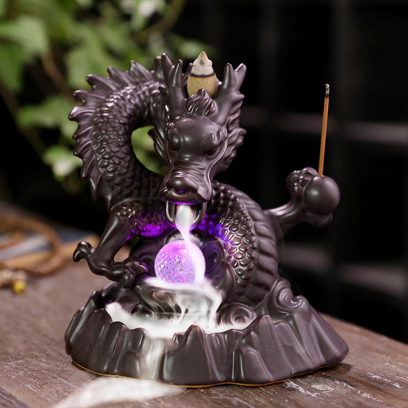 Elevate your home decor with our Ceramic Chinese Dragon Backflow Incense Burner. Watch as the intricately designed dragon releases a soothing flow of smoke, creating a serene atmosphere. Handcrafted from ceramic, this burner adds a touch of elegance and tradition to any space. Perfect for relaxation and meditation.