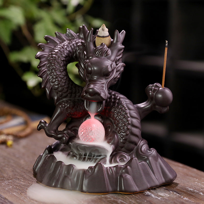 Elevate your home decor with our Ceramic Chinese Dragon Backflow Incense Burner. Watch as the intricately designed dragon releases a soothing flow of smoke, creating a serene atmosphere. Handcrafted from ceramic, this burner adds a touch of elegance and tradition to any space. Perfect for relaxation and meditation.