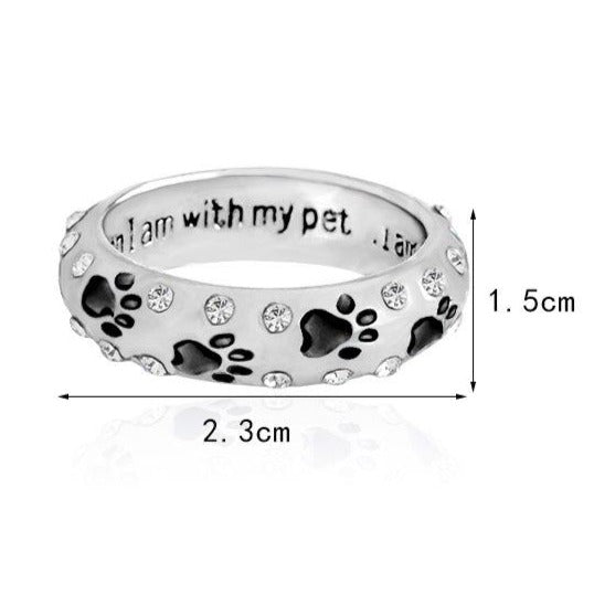 Capture the heartwarming bond between you and your furry best friend with our Dog Paw Prints Jewels Ring. This beautifully crafted ring features delicate paw prints, representing the unbreakable connection between you and your beloved dog. A must-have for any dog lover, this ring makes the perfect accessory to express your love and devotion.