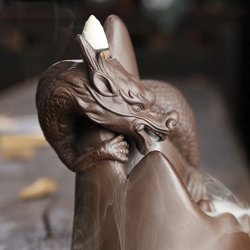 This handmade Purple Sand Dragon Backflow Incense Burner is the perfect addition to any room. With its intricate design and durable construction, you'll be enchanted by the mystical smoke that cascades down the figure.