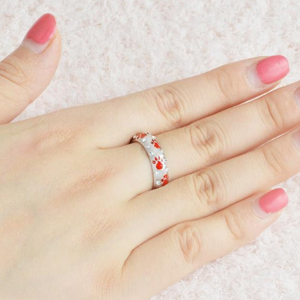 Capture the heartwarming bond between you and your furry best friend with our Dog Paw Prints Jewels Ring. This beautifully crafted ring features delicate paw prints, representing the unbreakable connection between you and your beloved dog. A must-have for any dog lover, this ring makes the perfect accessory to express your love and devotion.