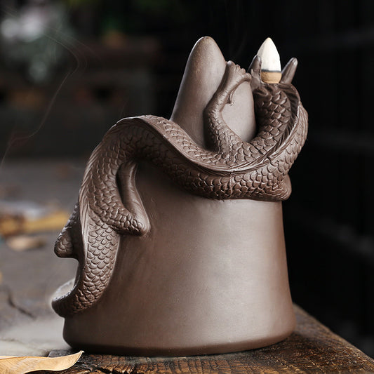 This handmade Purple Sand Dragon Backflow Incense Burner is the perfect addition to any room. With its intricate design and durable construction, you'll be enchanted by the mystical smoke that cascades down the figure.