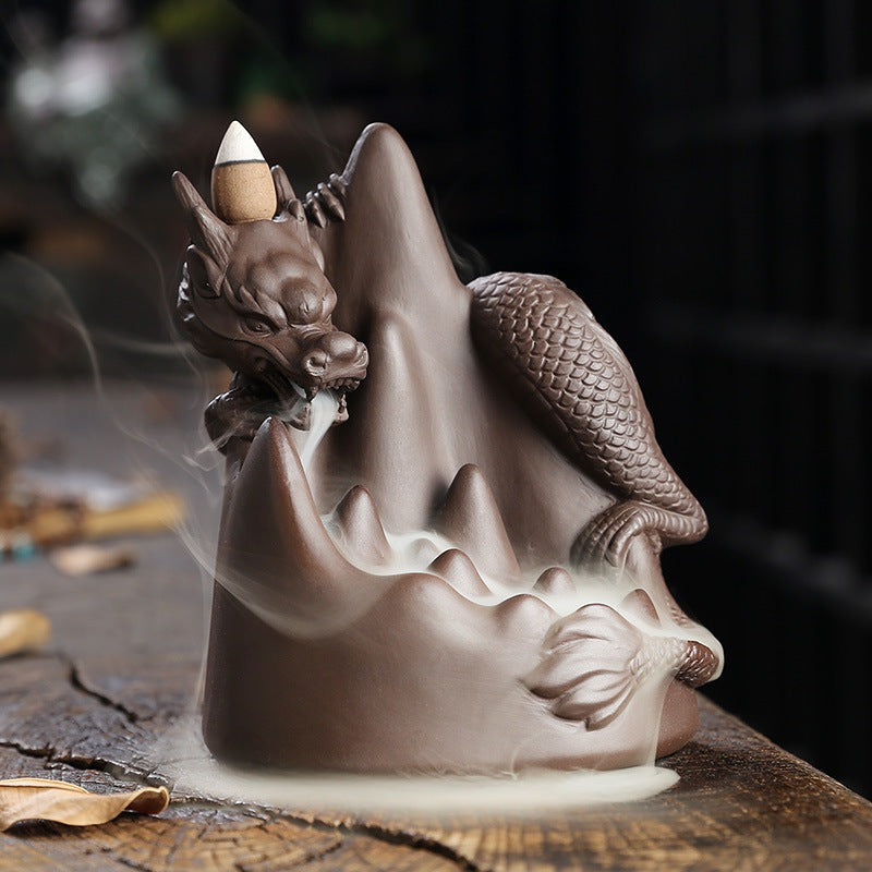 This handmade Purple Sand Dragon Backflow Incense Burner is the perfect addition to any room. With its intricate design and durable construction, you'll be enchanted by the mystical smoke that cascades down the figure.