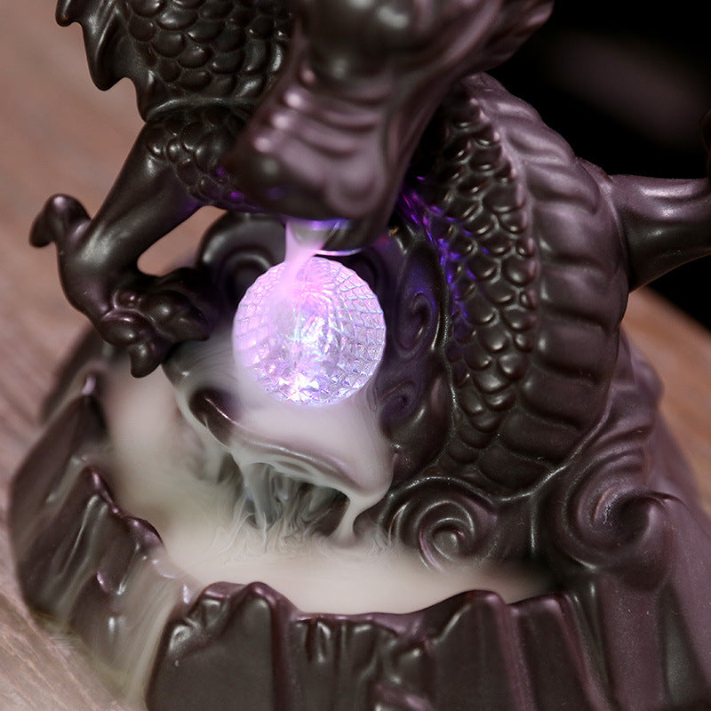 Elevate your home decor with our Ceramic Chinese Dragon Backflow Incense Burner. Watch as the intricately designed dragon releases a soothing flow of smoke, creating a serene atmosphere. Handcrafted from ceramic, this burner adds a touch of elegance and tradition to any space. Perfect for relaxation and meditation.