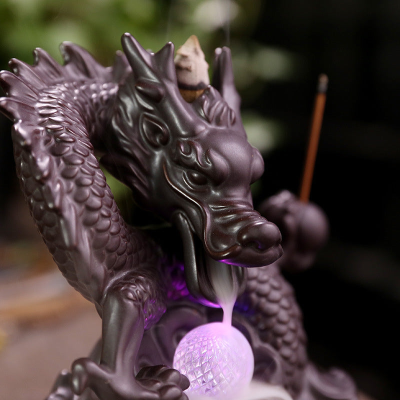 Elevate your home decor with our Ceramic Chinese Dragon Backflow Incense Burner. Watch as the intricately designed dragon releases a soothing flow of smoke, creating a serene atmosphere. Handcrafted from ceramic, this burner adds a touch of elegance and tradition to any space. Perfect for relaxation and meditation.