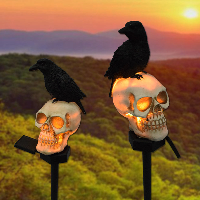 Illuminate your outdoor space with the daring Raven on Skull Solar Yard Lighting. This striking light features a raven perched atop a skull, casting an eerie glow powered by solar energy.