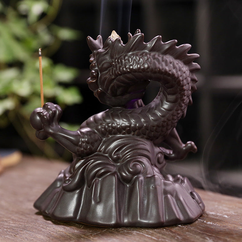 Elevate your home decor with our Ceramic Chinese Dragon Backflow Incense Burner. Watch as the intricately designed dragon releases a soothing flow of smoke, creating a serene atmosphere. Handcrafted from ceramic, this burner adds a touch of elegance and tradition to any space. Perfect for relaxation and meditation.