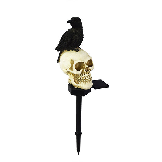 Illuminate your outdoor space with the daring Raven on Skull Solar Yard Lighting. This striking light features a raven perched atop a skull, casting an eerie glow powered by solar energy.