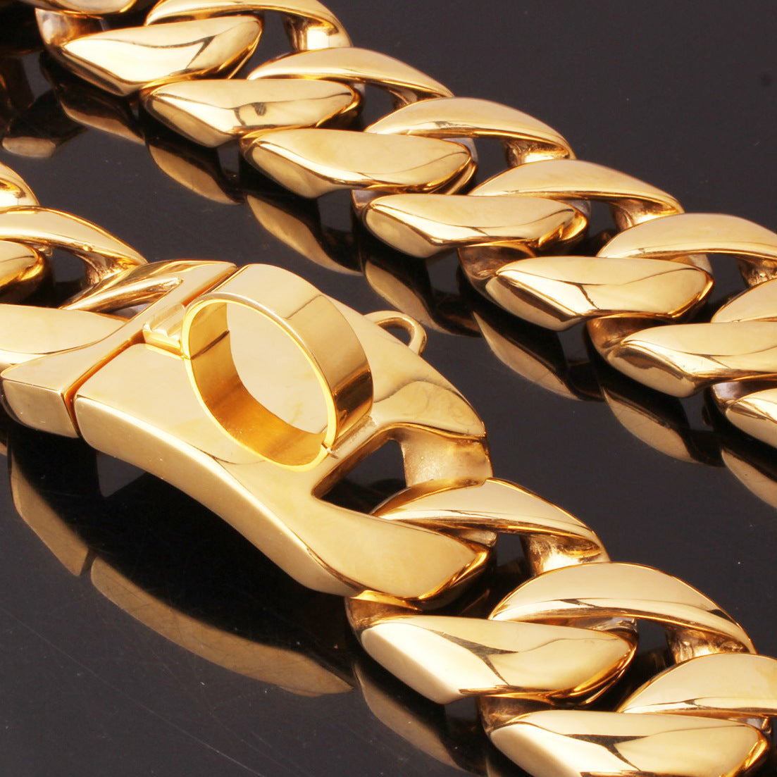 Gold chain on a reflective black surface