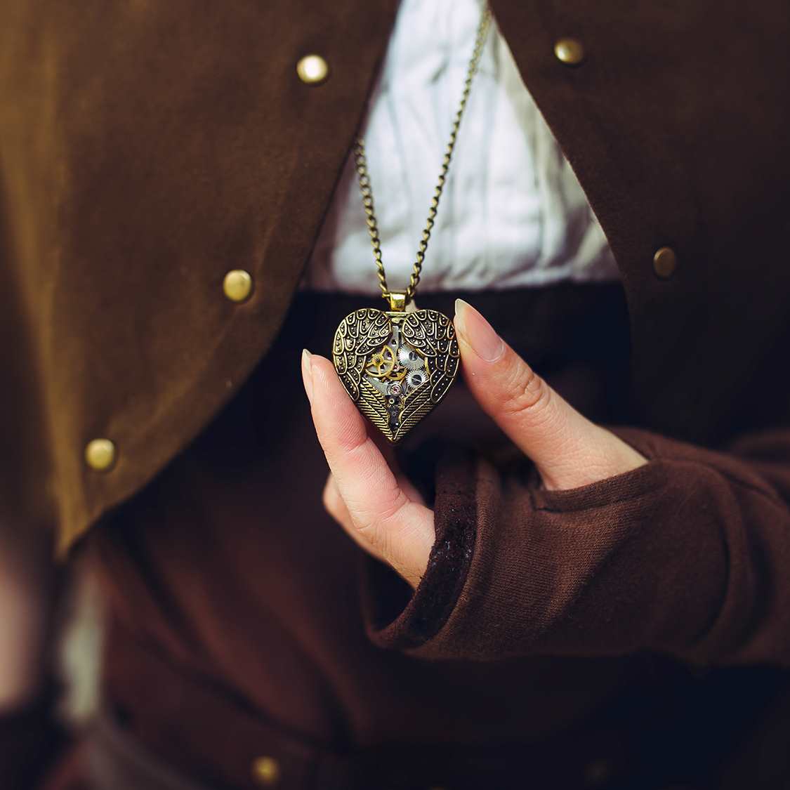 This steampunk gear heart necklace perfect addition to your Reissuance Fair outfit! Well made chain designed out of silver alloy and gold-plated with an inlay of artificial gems and semi-precious stones. The pendant is a lovely waterdrop or a heart.