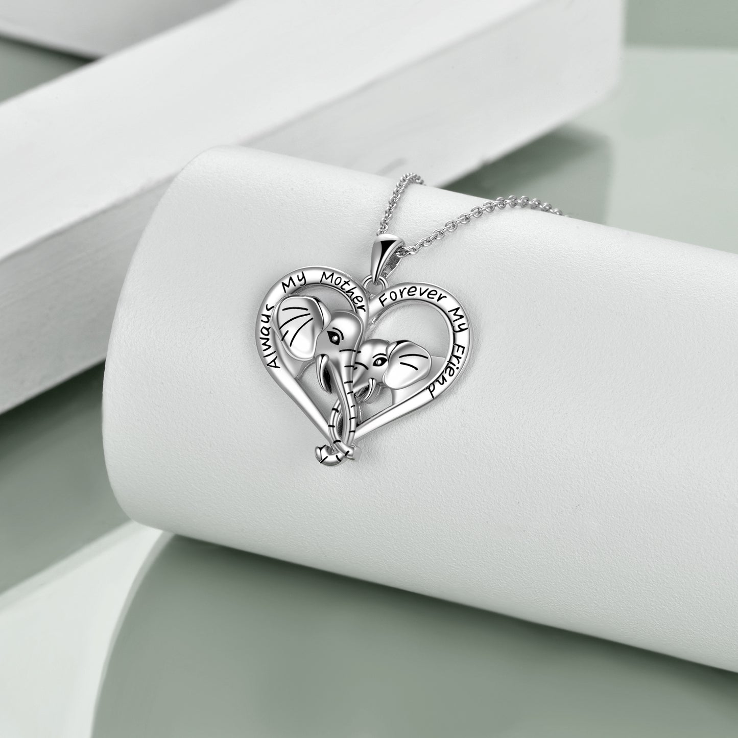 Mama elephant and baby elephant tied noses together, which represents the maternal love and harmonious relationship between mother and daughter. It engraved "Always My Mother Forever My Friend". Perfect mother daughter necklace for animal lovers.