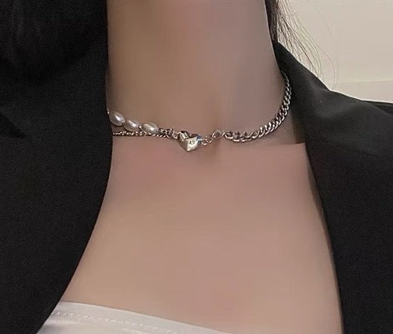 This chic Pearl & Metal Chain Heart Choker is crafted from a combination of metal and pearl chains that provide a luxuriously sophisticated look. The heart-shaped pendant adds a stylish, eye-catching detail that makes this piece a must-have accessory. Its adjustable chain ensures a comfortable, snug fit.