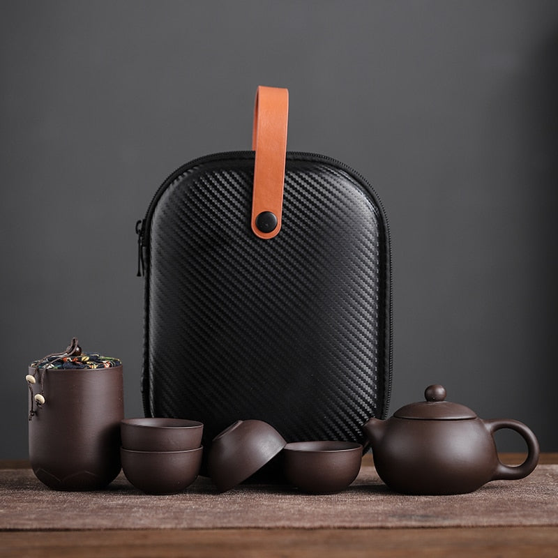 This Ceramic purple sand portable teapot set Features xishi teapot design, there is a filter in the spout of the teapot, the tea leaf and the tea water can be separated automatically, the beautiful details of this traditional Chinese craftsmanship will bring beauty and elegance to your living room or office. suitable size, convenient to carry, safe and easy to store with portable storage bag.