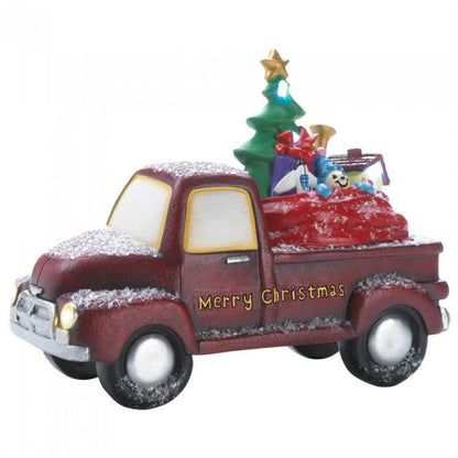 This charming old-time truck is carrying a full assortment of toys that look like they're nestled right in Santa's bag. The red truck reads "Merry Christmas" in gold on the side. The headlights light up as well as some of the toys.