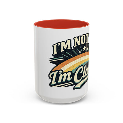 White mug with red interior and colorful text design on a white background