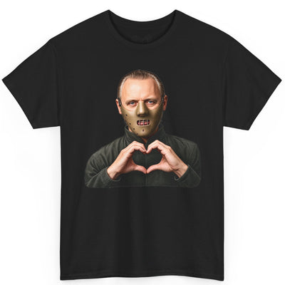 A black short-sleeve crewneck t-shirt featuring a graphic print of a man wearing a metallic zombie mask and making a heart shape with his hands, displayed on a solid white background.