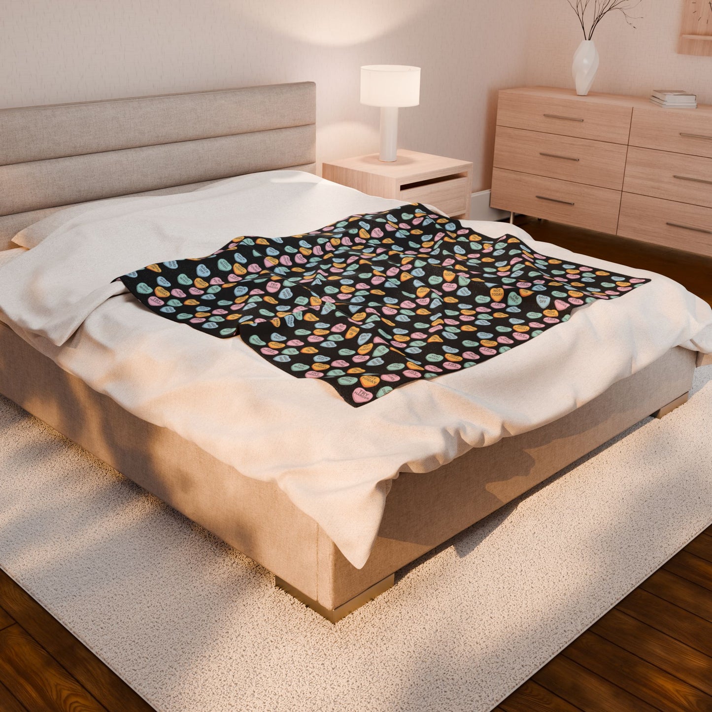 Bed with a colorful patterned blanket in a bedroom setting
