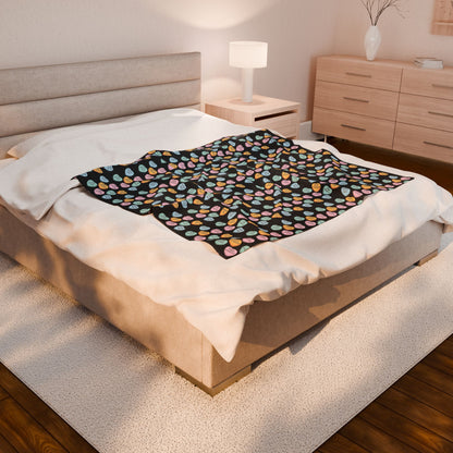 Bed with a colorful patterned blanket in a bedroom setting