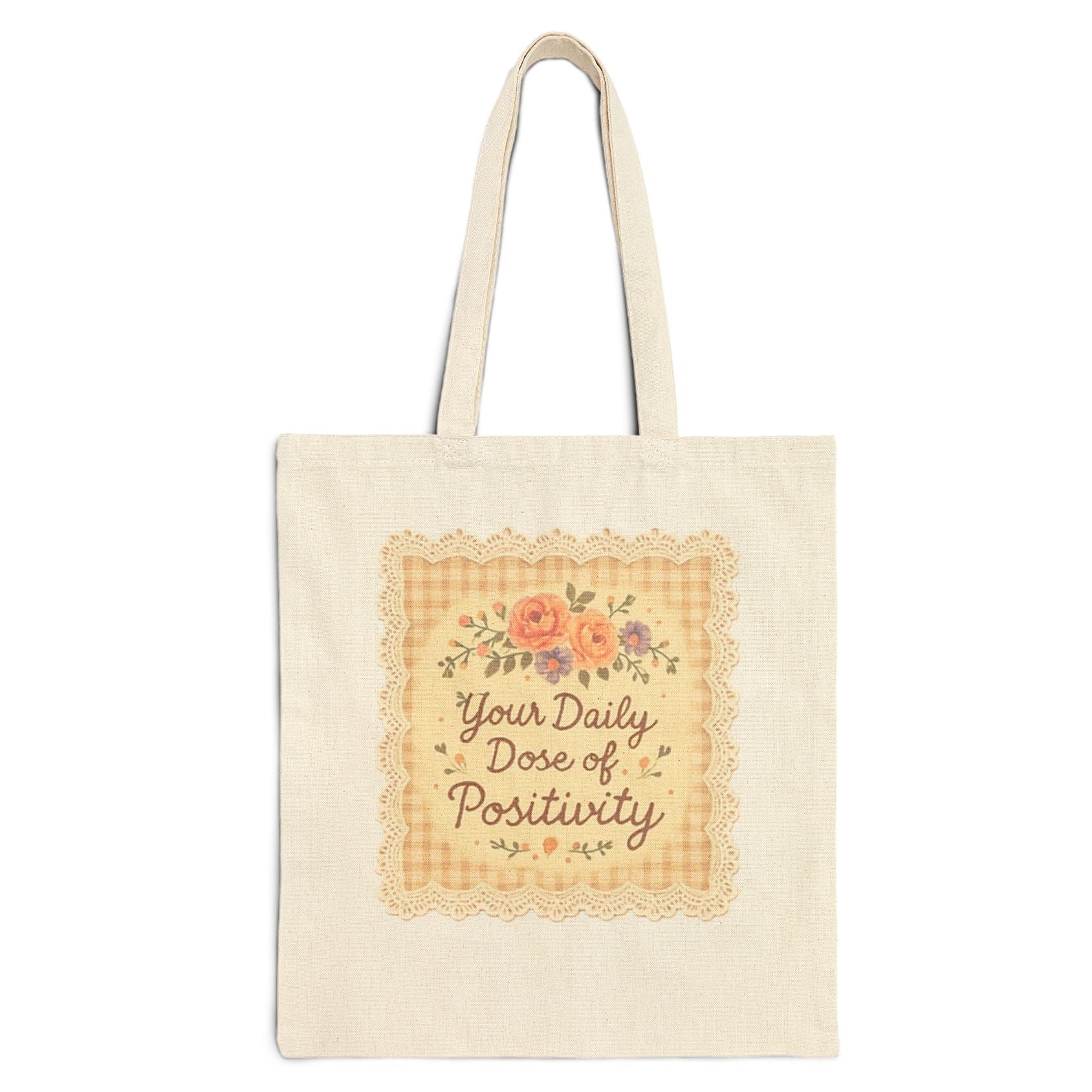 Tote bag with 'Your Daily Dose of Positivity' text and floral design on a white background