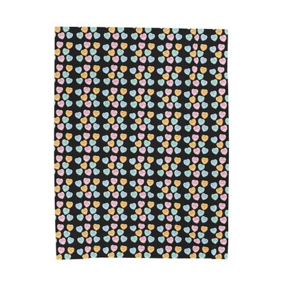 Patterned fabric with colorful hearts on a black background