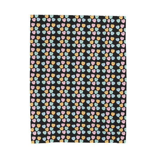 Patterned fabric with colorful hearts on a black background
