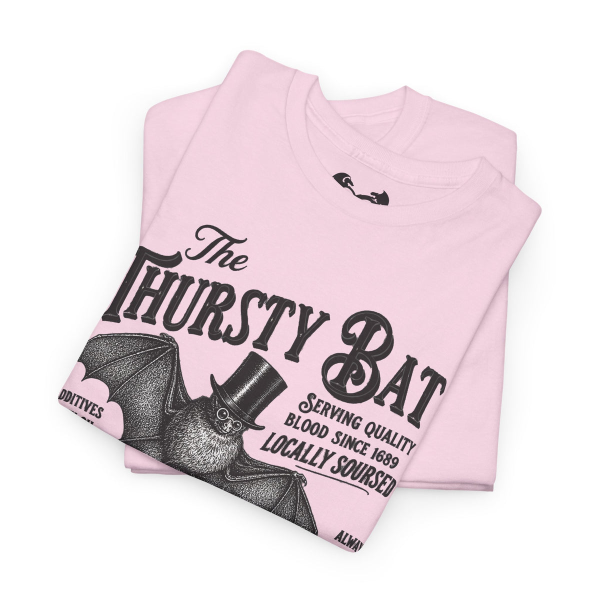 A folded white short-sleeve T-shirt with a large black graphic print reading 'The Thirsty Bat' and a bat illustration wearing a top hat, photographed on a clean white background.
