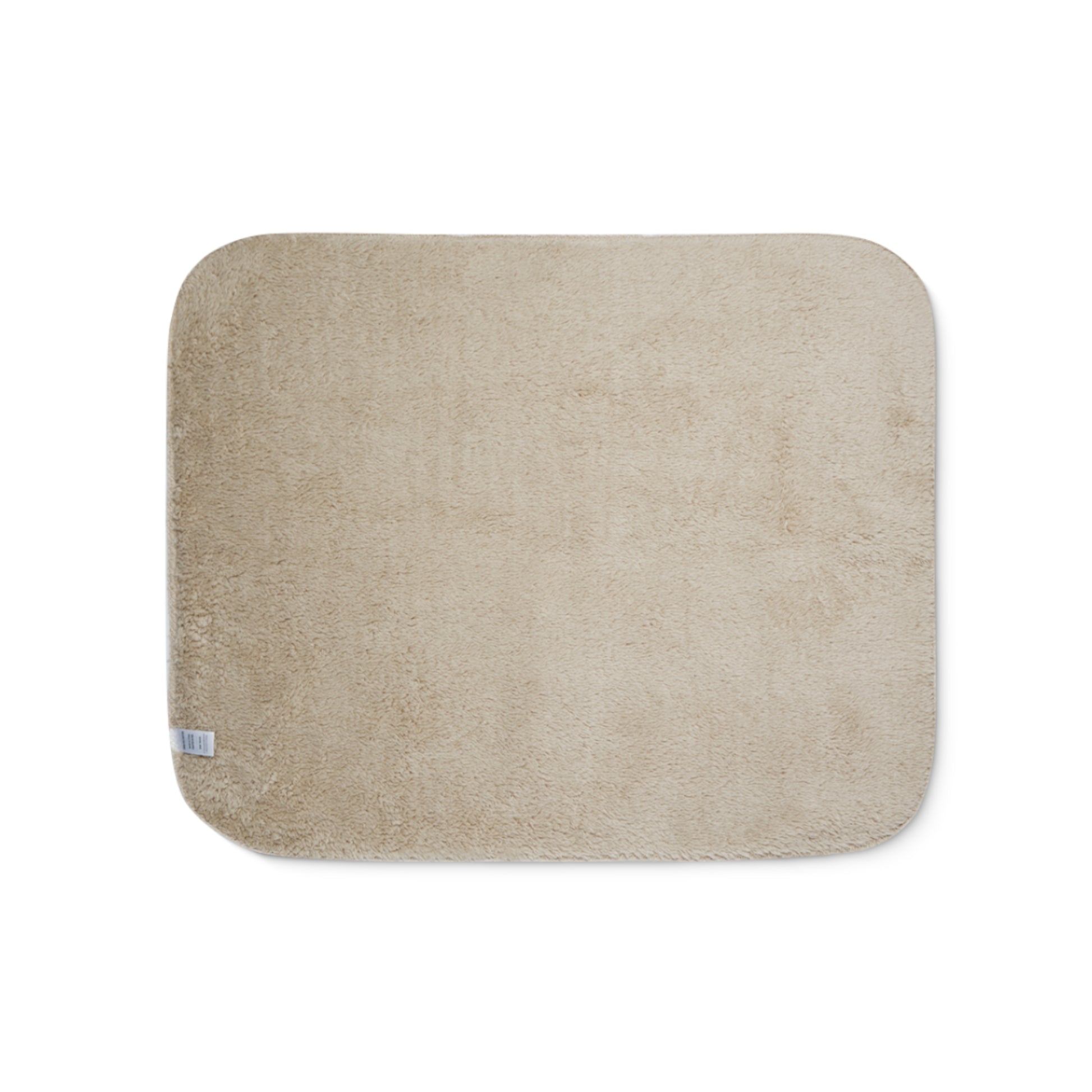 Beige bath mat on a white background