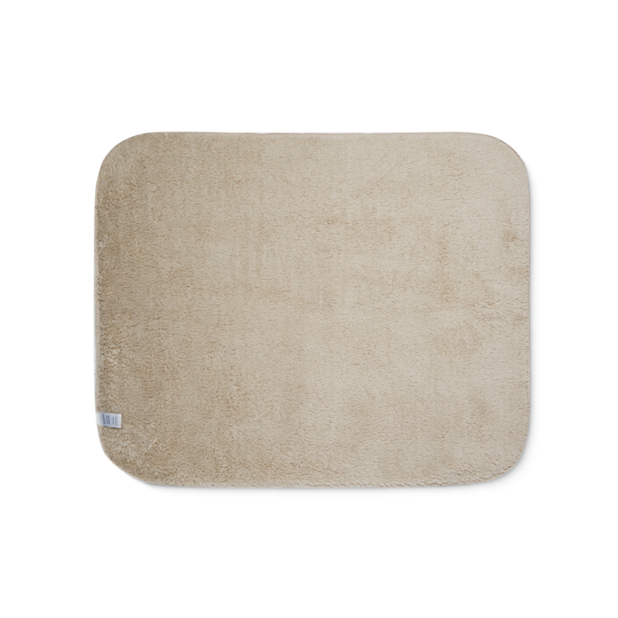 Beige bath mat on a white background