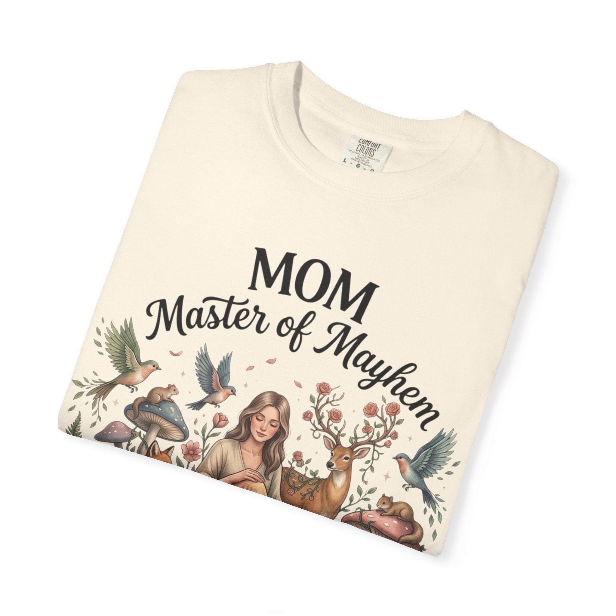 Folded t-shirt with 'Mom Master of Mayhem' text and nature-themed design on a white background