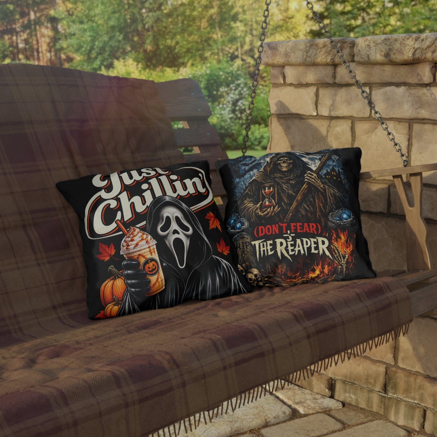 Two Halloween-themed throw pillows displayed on a hanging porch swing with a stone wall and patio in the background. The left pillow features the Ghostface graphic with the text 'Just Chillin'' and a pumpkin drink.