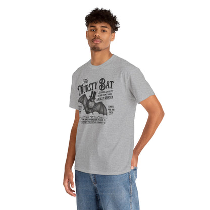 A man wearing a heather gray graphic t-shirt with a black print of a bat and the text 'The Thursty Bat'.