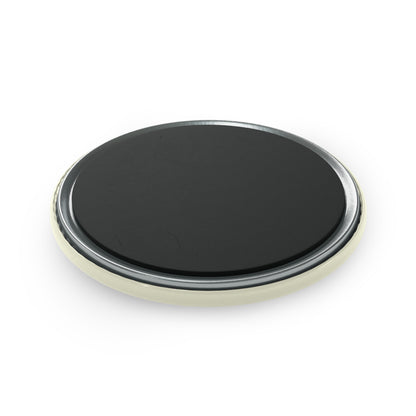 Round black object with metallic rim on a white background