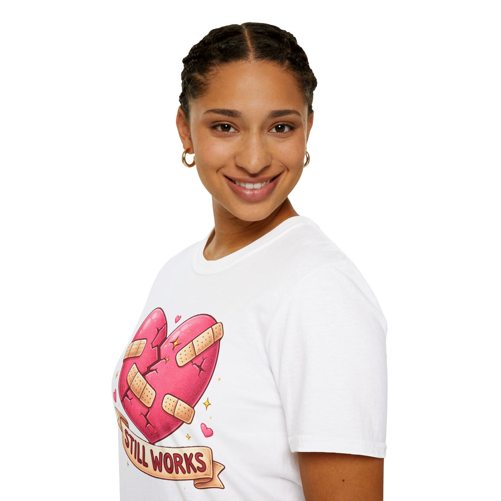 Person wearing a white t-shirt with a graphic design of a heart with band-aids and text on a white background