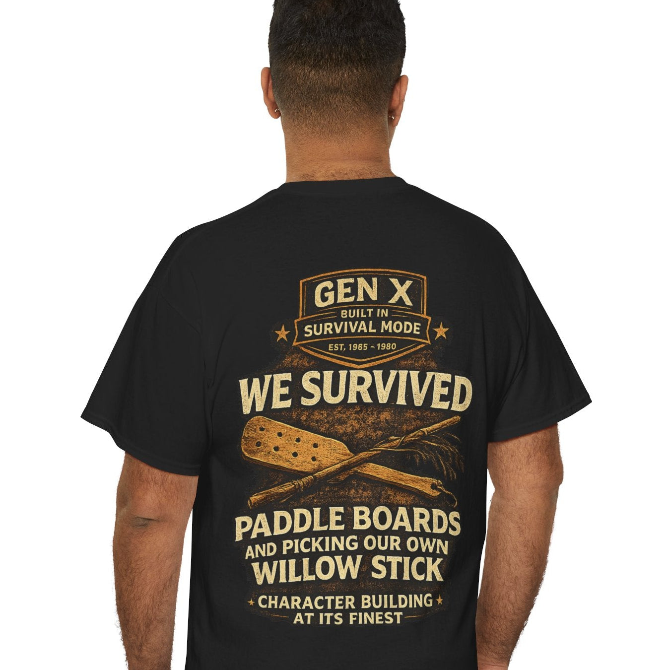 Person wearing a black t-shirt with humorous text and graphics on the back, standing against a white background.