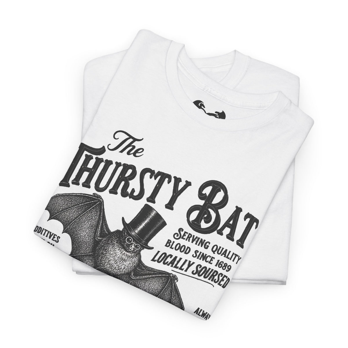 A folded white short-sleeve T-shirt with a large black graphic print reading 'The Thirsty Bat' and a bat illustration wearing a top hat, photographed on a clean white background.