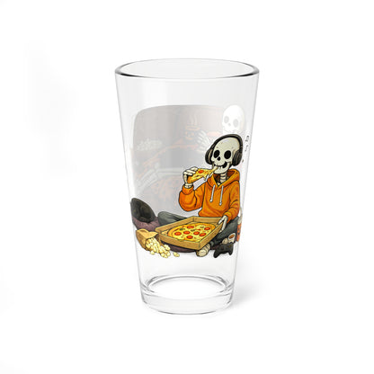 A clear glass pint tumbler featuring a cartoon illustration of a skeleton wearing headphones and eating pizza, shown on a plain white background.