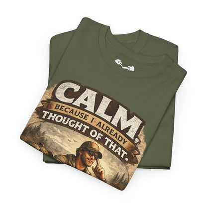 Folded green t-shirt with humorous graphic and text on a white background
