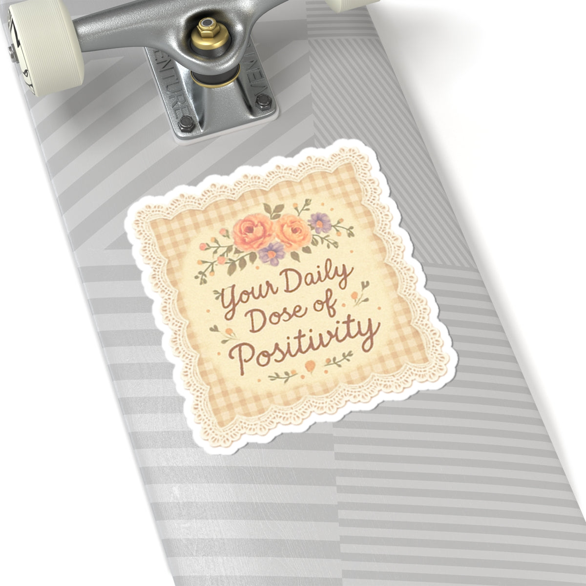 Decorative sticker with 'Your Daily Dose of Positivity' text on a skateboard deck.