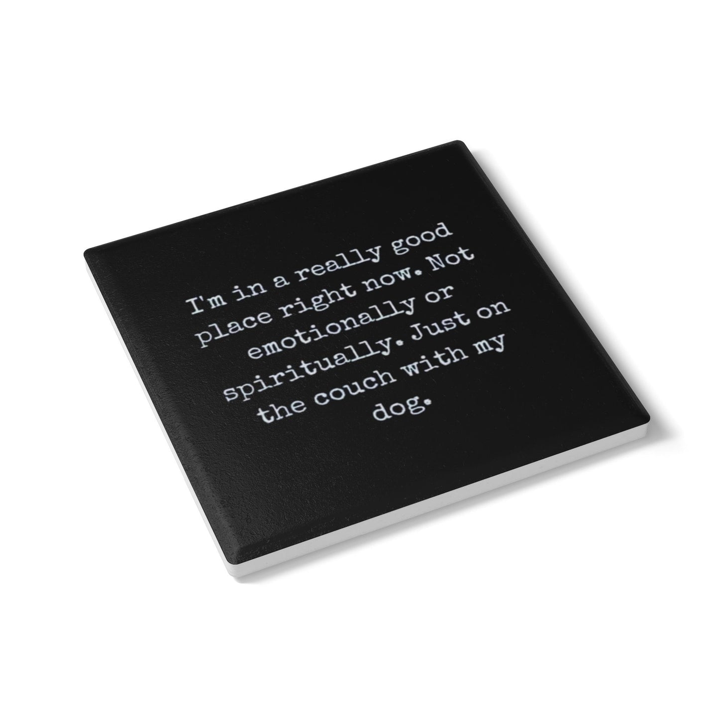Black coaster with white text on a white background
