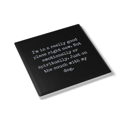 Black coaster with white text on a white background