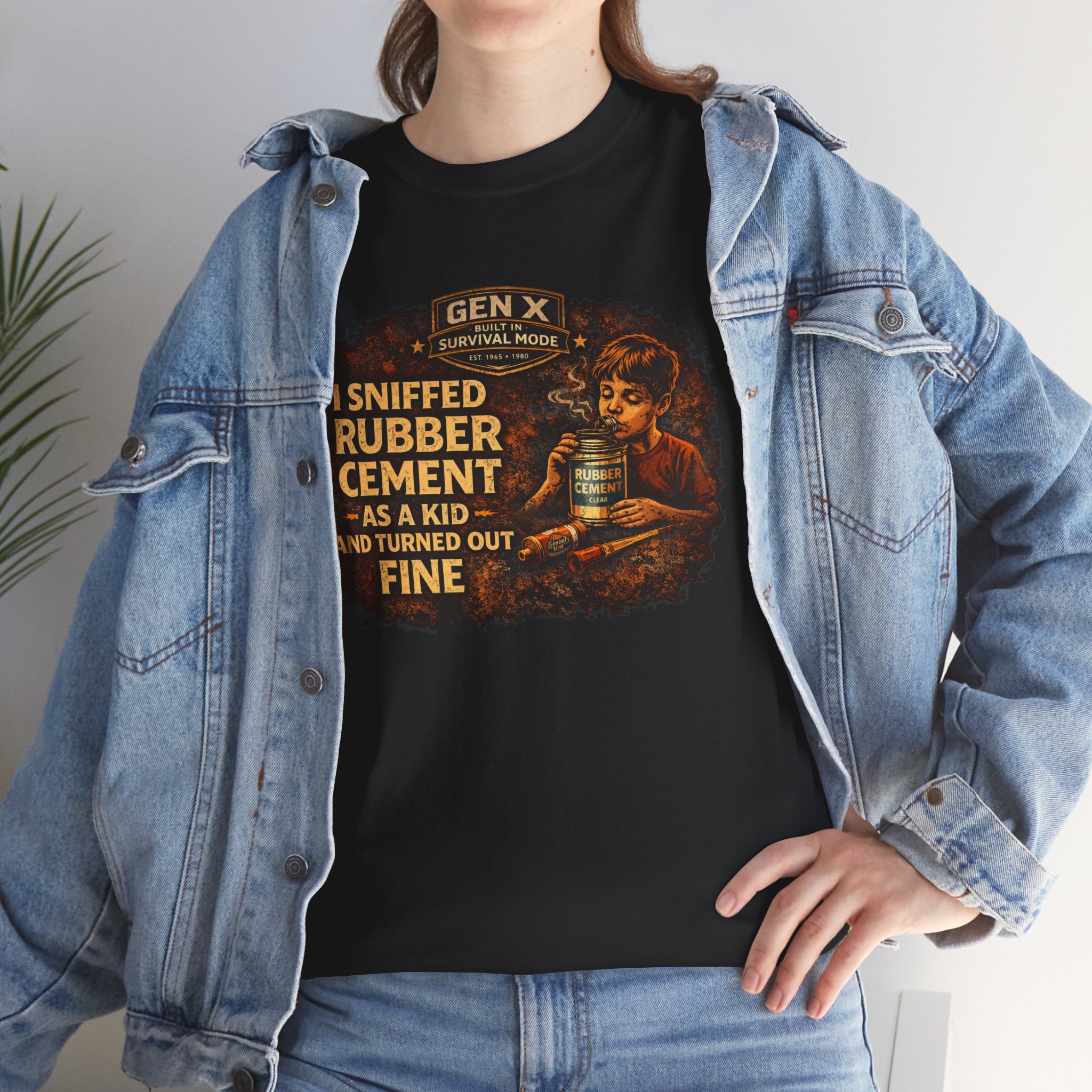 Person wearing a black t-shirt with a graphic design and text, paired with a denim jacket.